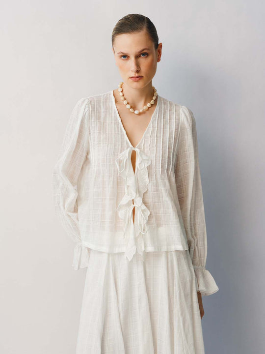 Blusa a quadri in cotone con volant, chiusura frontale con laccio e maniche lunghe