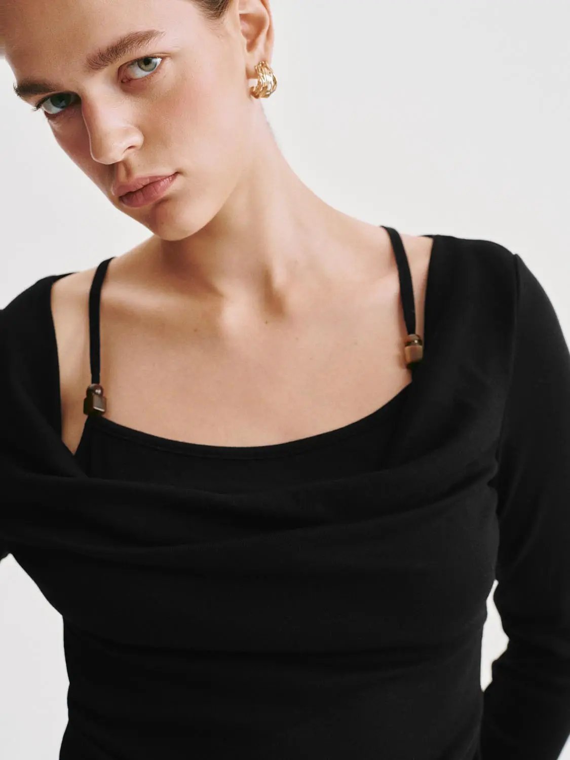 Black T-shirt with off-shoulder draped neckline and thin straps