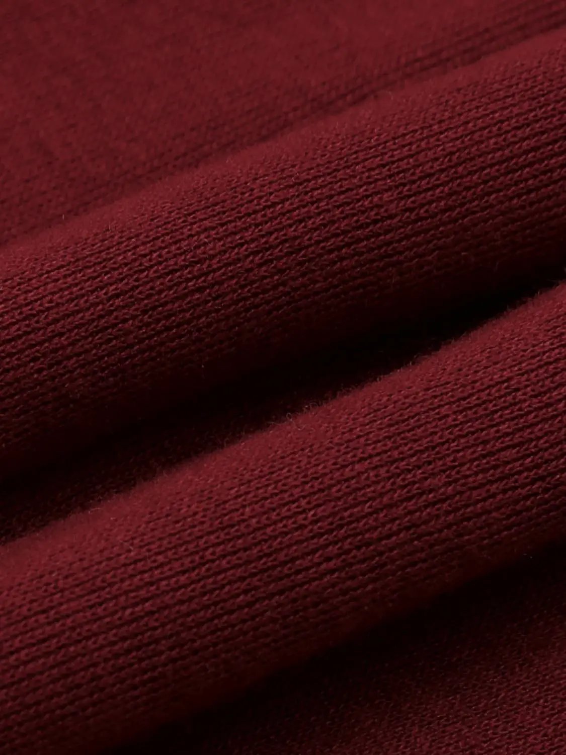T‑Shirt fabric close-up in burgundy knit texture, rich color
