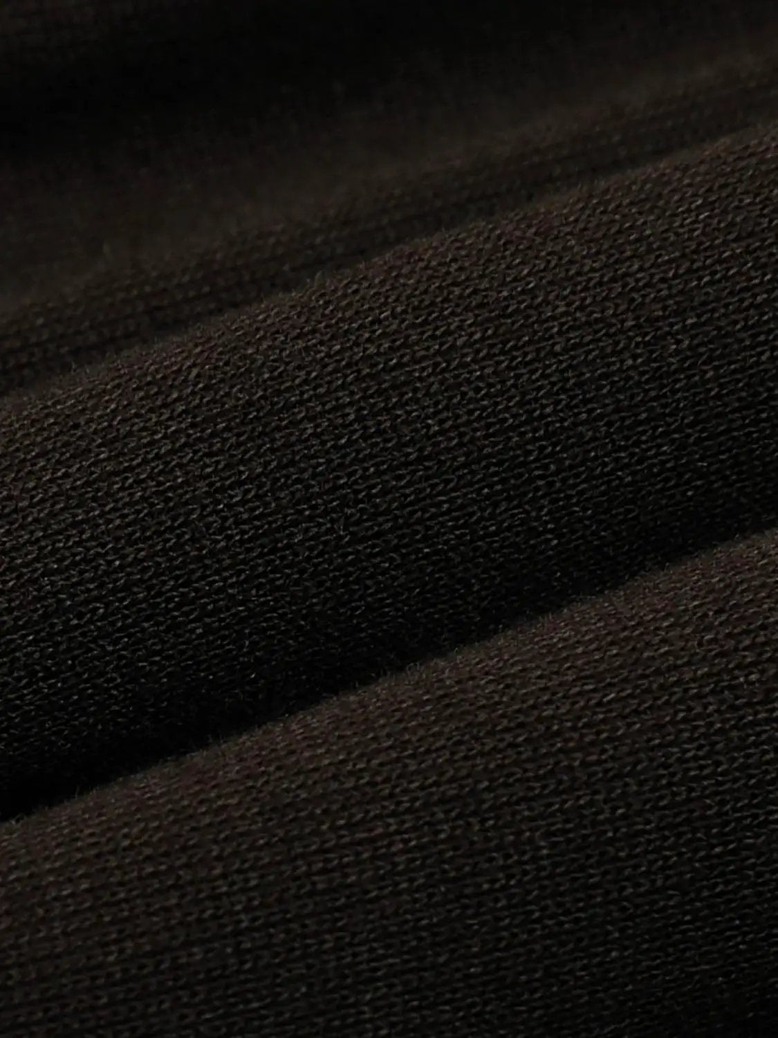 T-shirt fabric close-up in black knit texture with tight weave