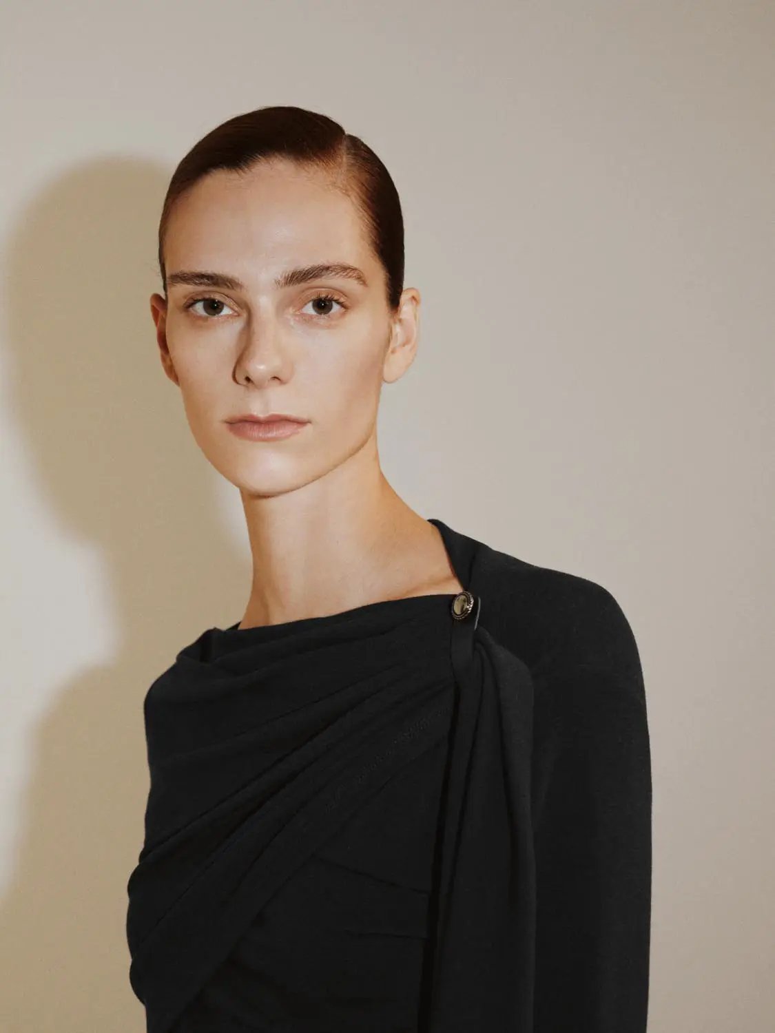 Draped one-shoulder long-sleeve black blouse with wrapped front detail, Urban Revivo Fashion brand, shoulder accent
