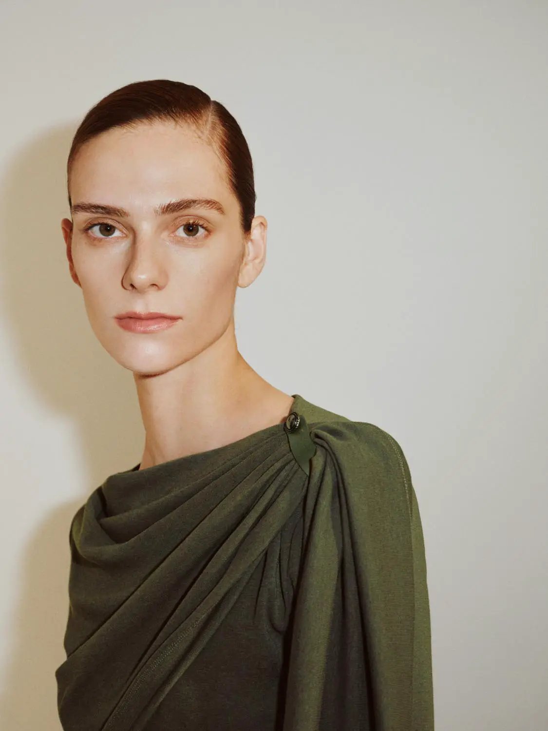 Draped One-Shoulder Long Sleeve Blouse in olive green with shoulder button detail