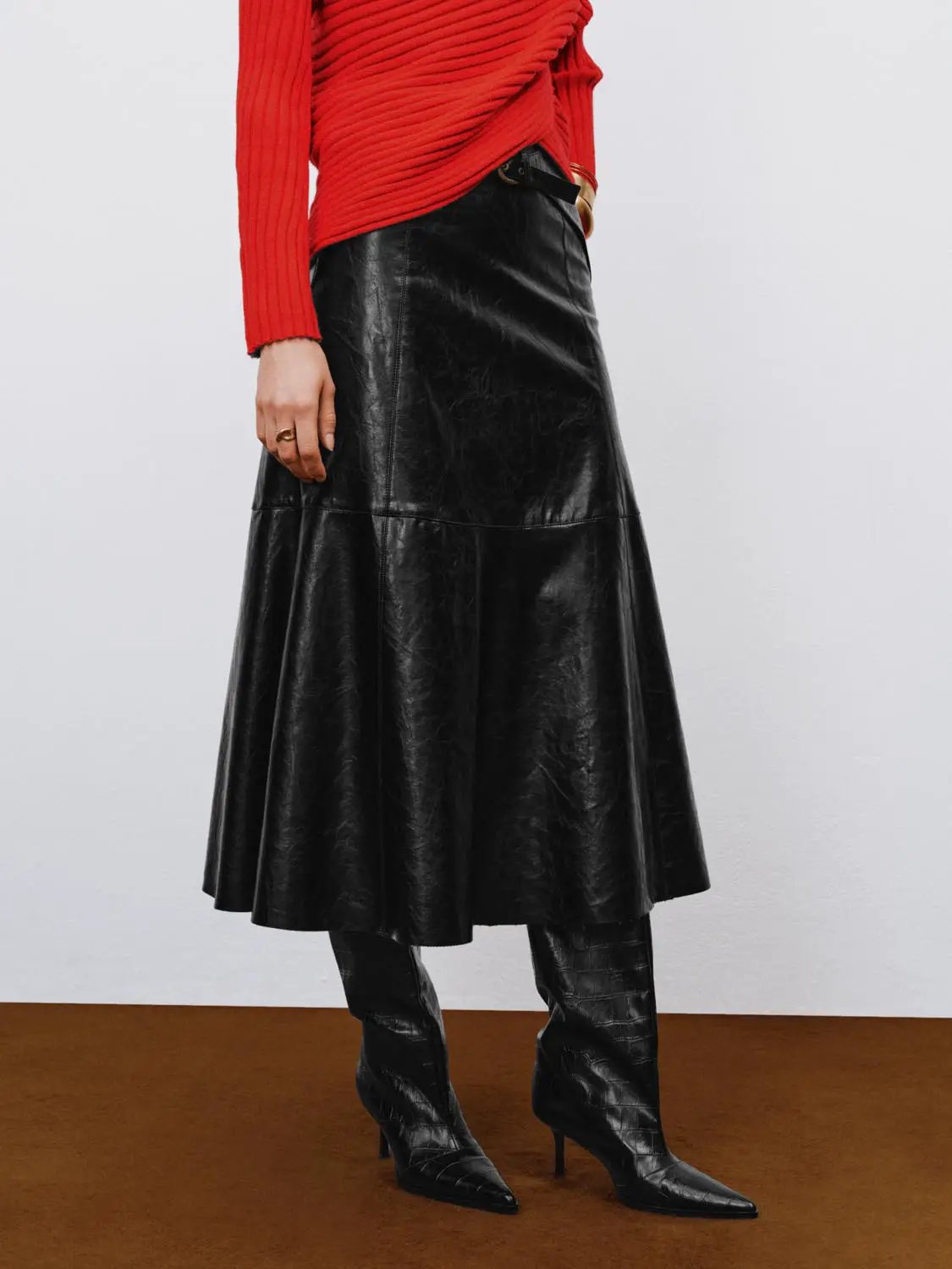 A-Line Skirt in black faux leather with panel seams, midi length