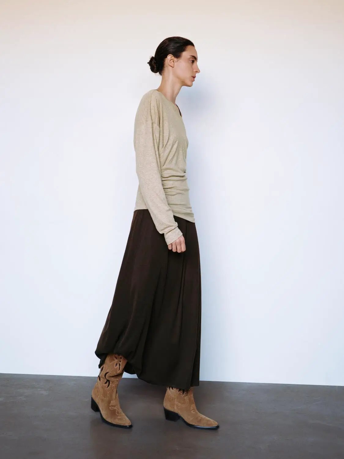Ruched Asymmetric Long Sleeve A-Line Maxi Dress; beige top paired with a dark brown skirt and tan boots