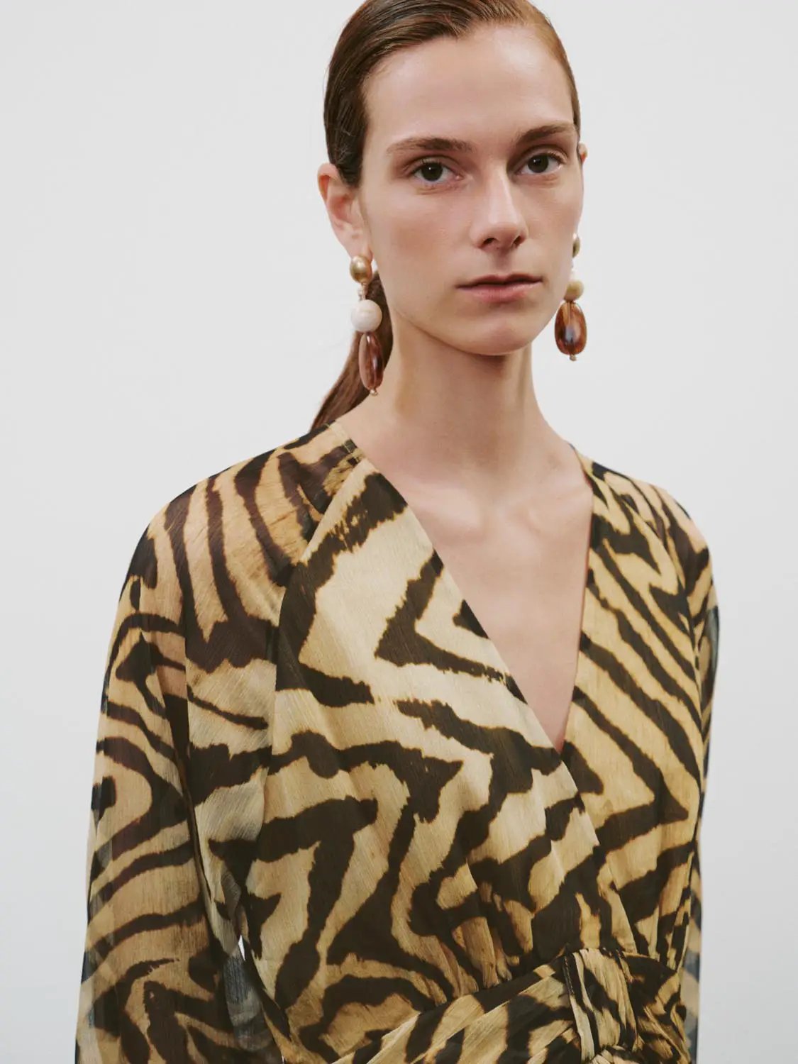 A-line dress in beige tiger-print with wrap V-neck and belted waist