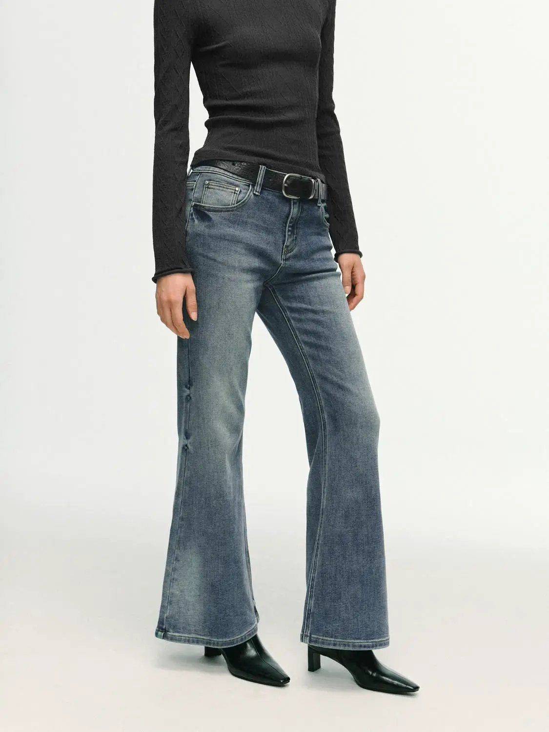 High-waisted stretch cotton blend flare jeans in blue denim, shown with a black top and belt.