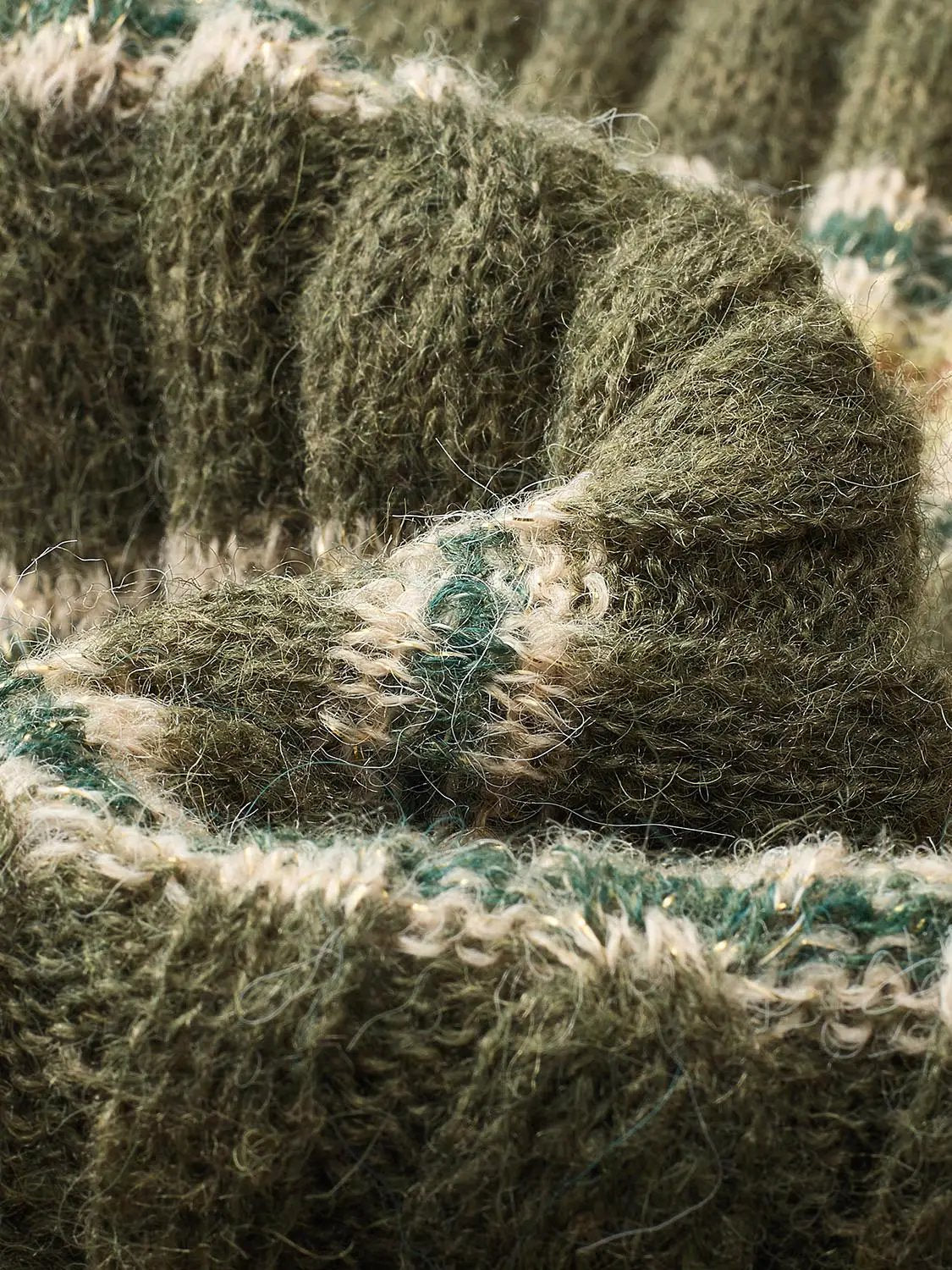 Knitted T-Shirts fabric in olive green with beige flecks and fuzzy texture