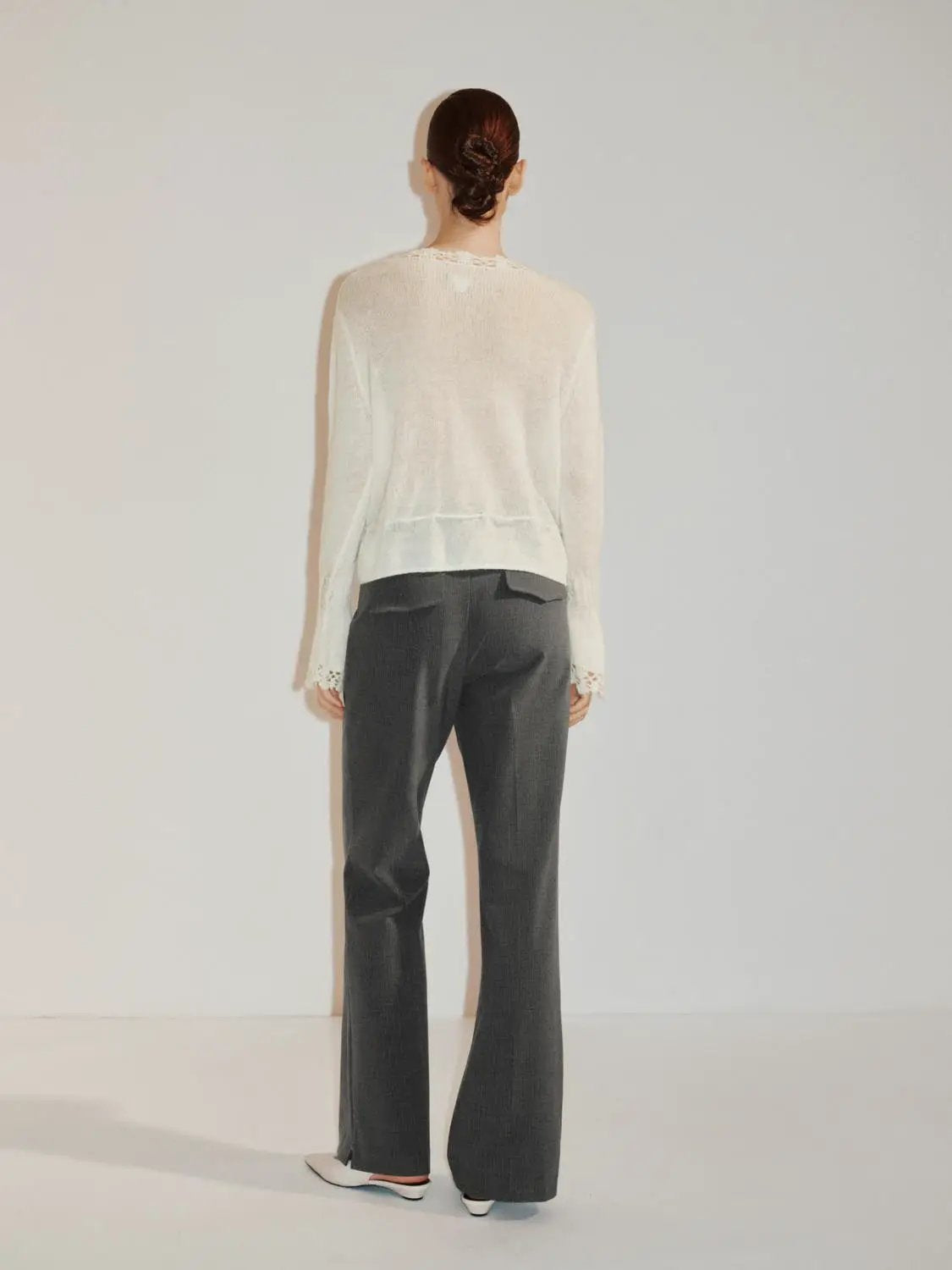 Textured button-front white knitted cardigan, long sleeves.