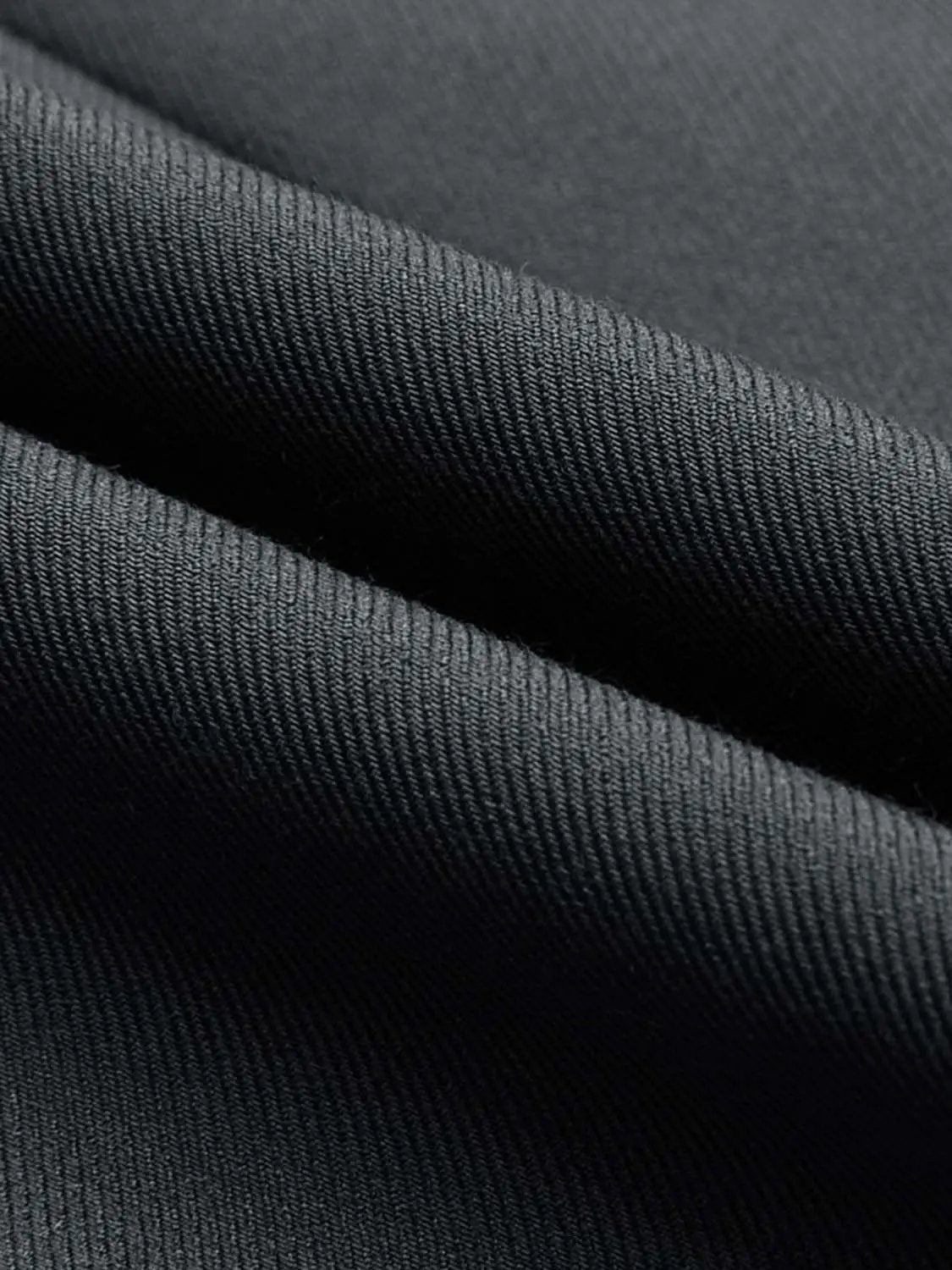 Sleeveless vest fabric close-up in black with a textured weave