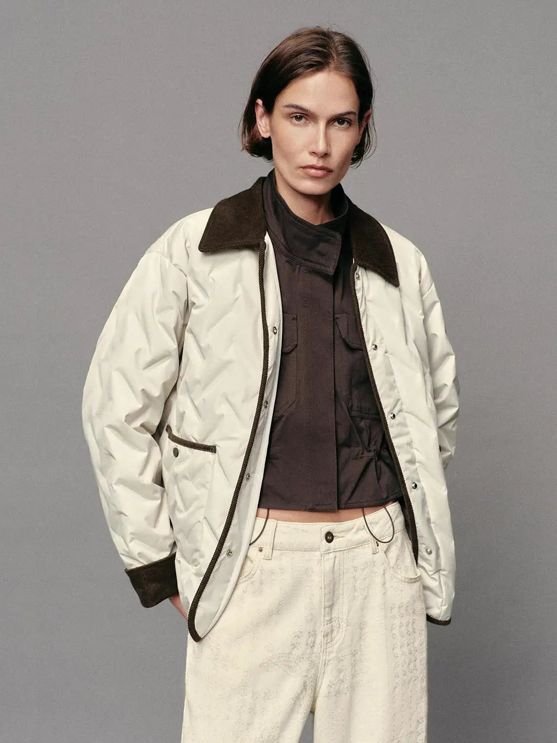 Down Jacket in cream with brown corduroy collar; oversized quilted puffer.
