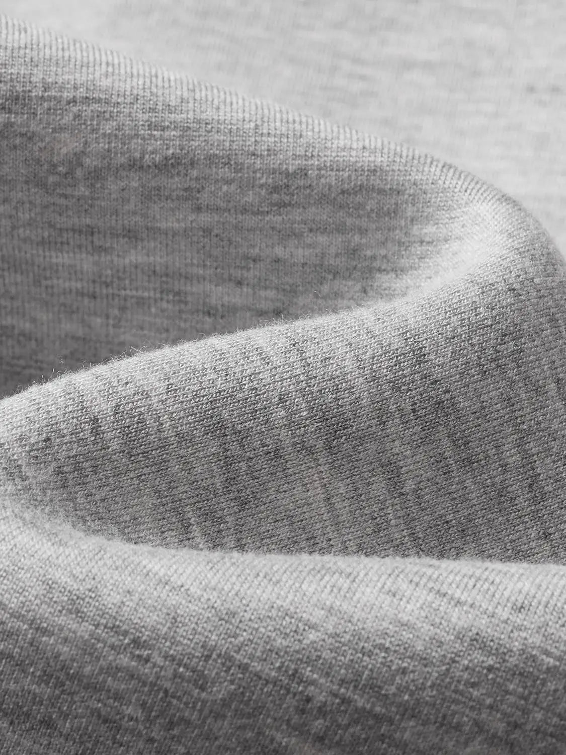 Sweatshirt jacket in gray knit fabric; close-up textile texture.