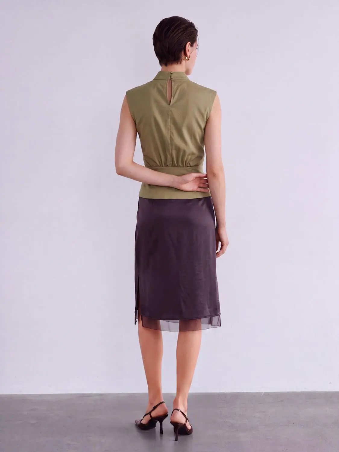 Blouse; olive sleeveless overhead shirt with back keyhole, paired with purple satin midi skirt. Urban Revivo Fashion.