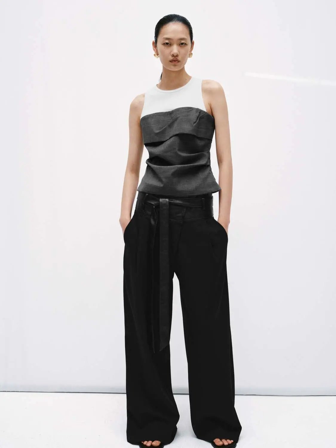 Urban Revivo 2in1 Layered Ruched Tank Top; white sleeveless top with layered bodice, paired with black wide-leg trousers.