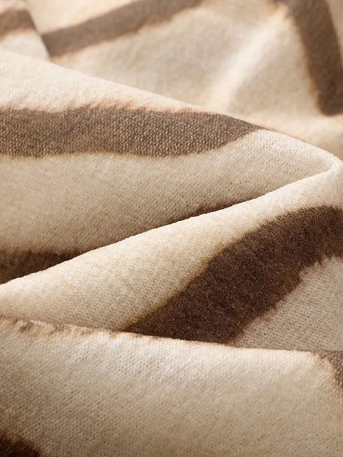 T‑Shirt fabric close-up showing soft beige and brown striped knit texture with visible fibers and subtle folds