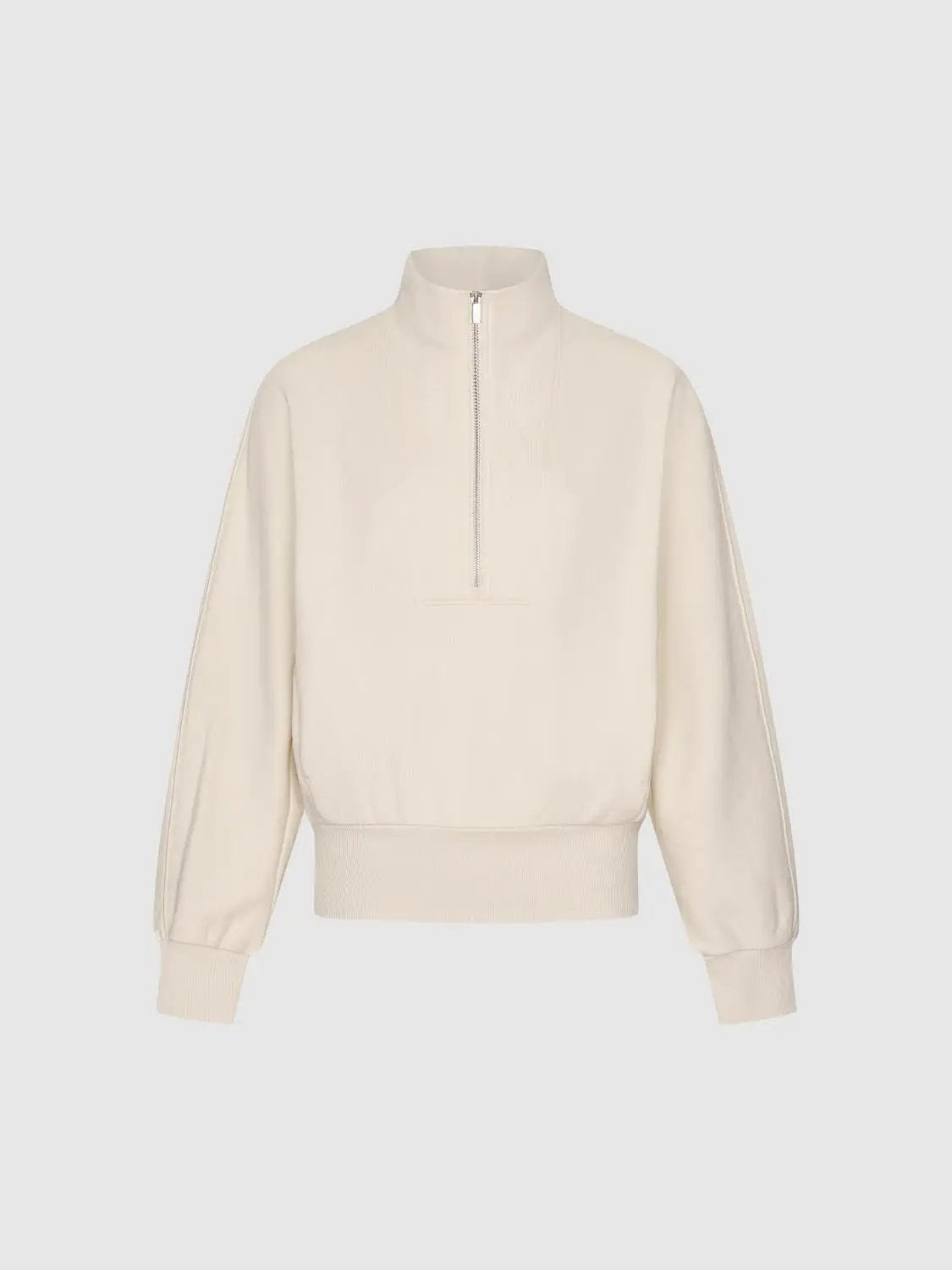 Sweatshirt in cream with a high collar and half-zip, ribbed cuffs and hem.