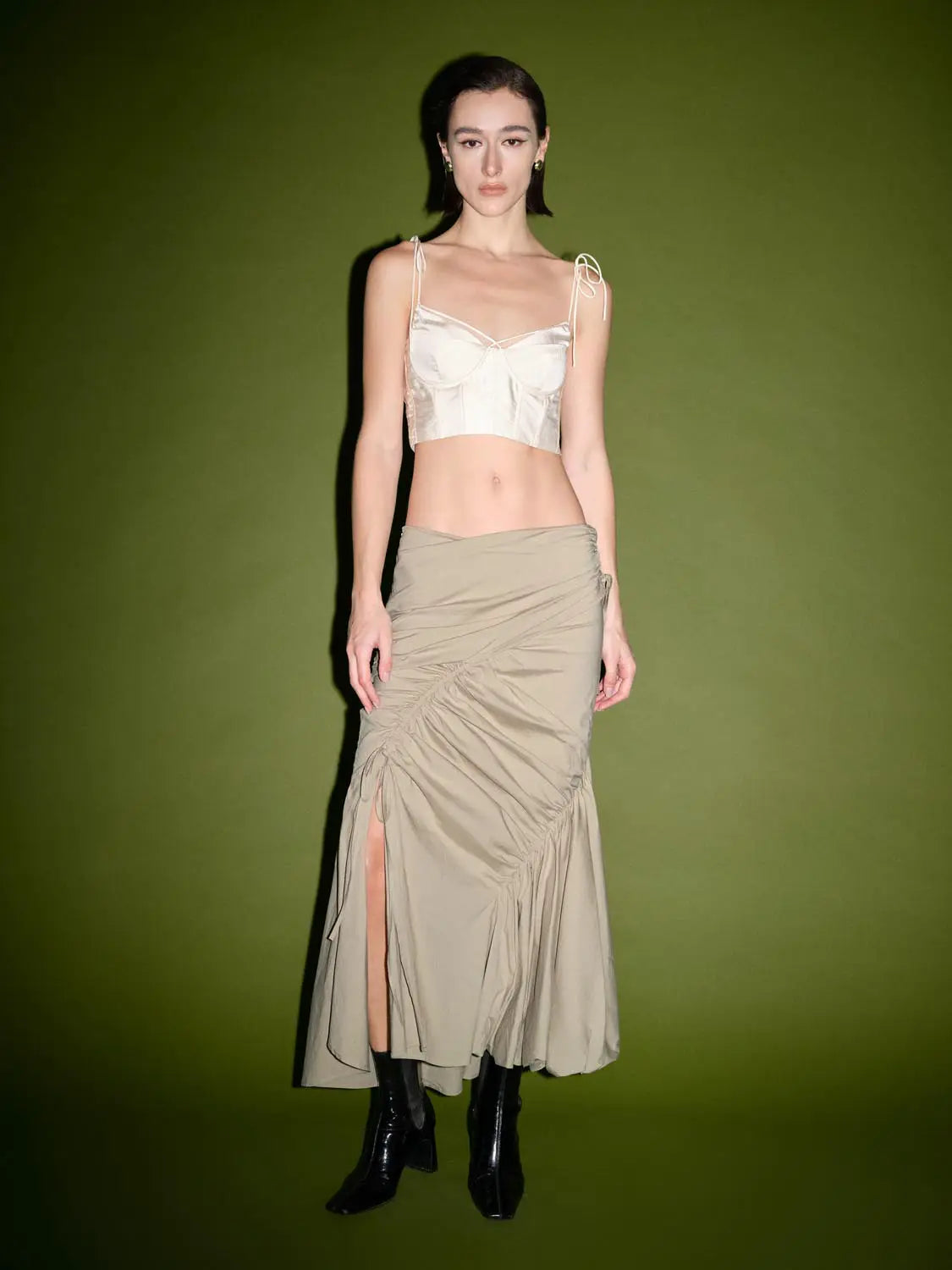 Ruched split-hem fishtail cotton midi skirt in beige, shown on model with side slit