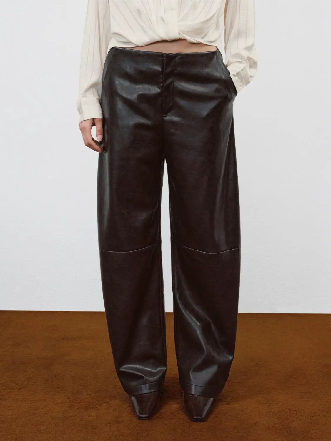 Mid-rise Curved-leg Faux Leather Pants in black for versatile wear