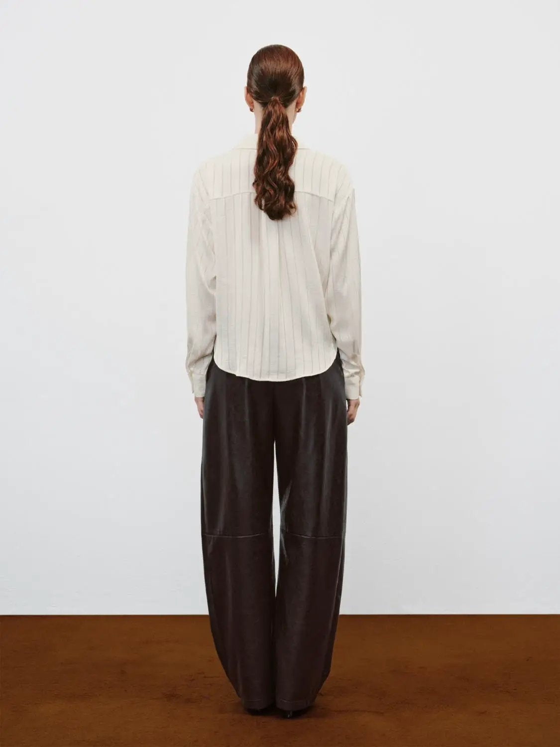 Mid-rise Curved-leg Faux Leather Pants in dark brown by Urban Revivo Fashion