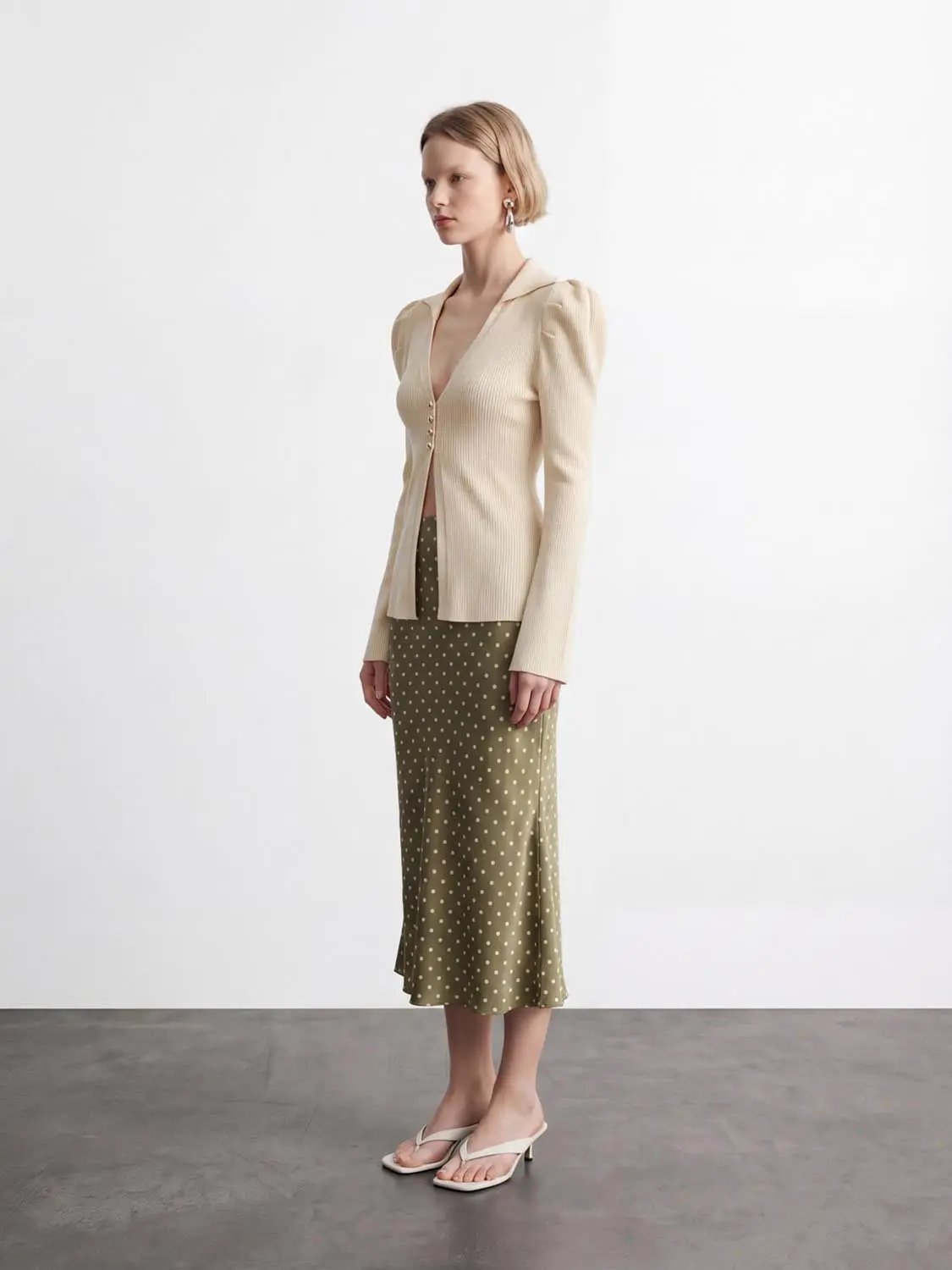 Puff Shoulder Tailored Knitted Cardigan in beige with front buttons.
