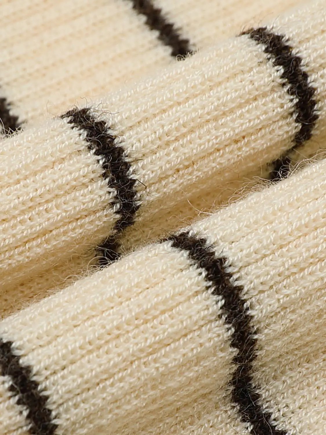 Striped beige knit T-shirt fabric with dark brown stripes; close-up texture