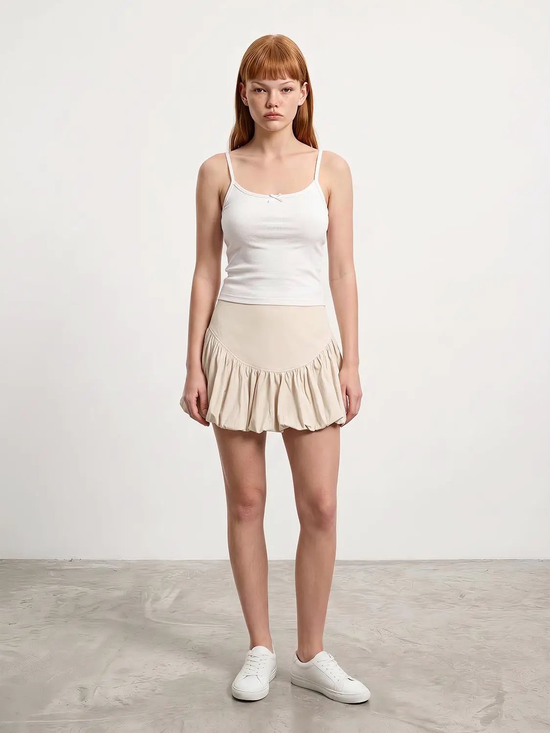 Cotton tiered ruffle A-line skirt in beige, shown with white sneakers.