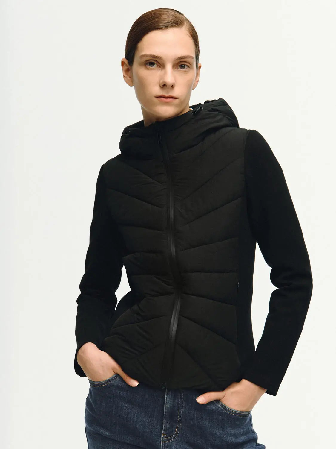 Padded jacket with hood; black quilted front, solid sleeves, front zipper.