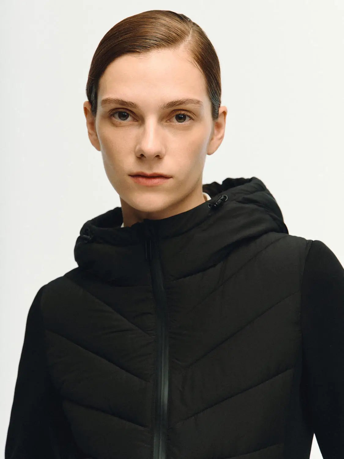 Padded jacket with hood in black; chevron quilted design, Urban Revivo Fashion.