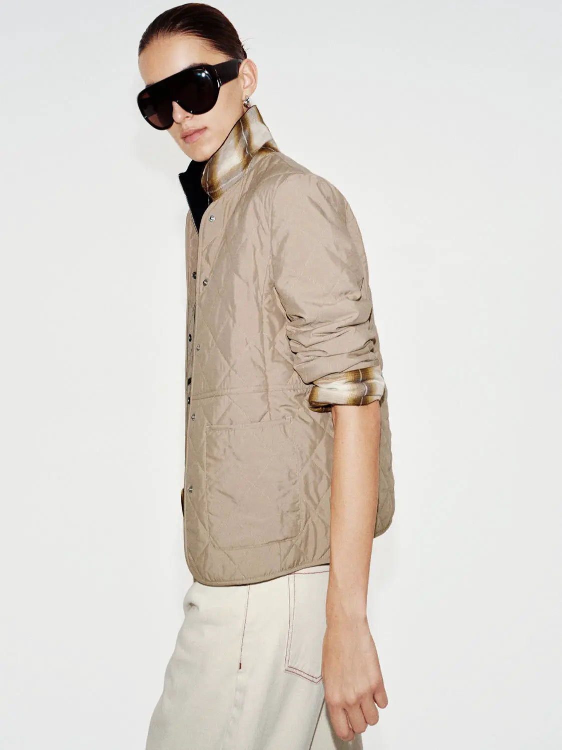 Padded jacket in beige, quilted with rolled plaid cuffs