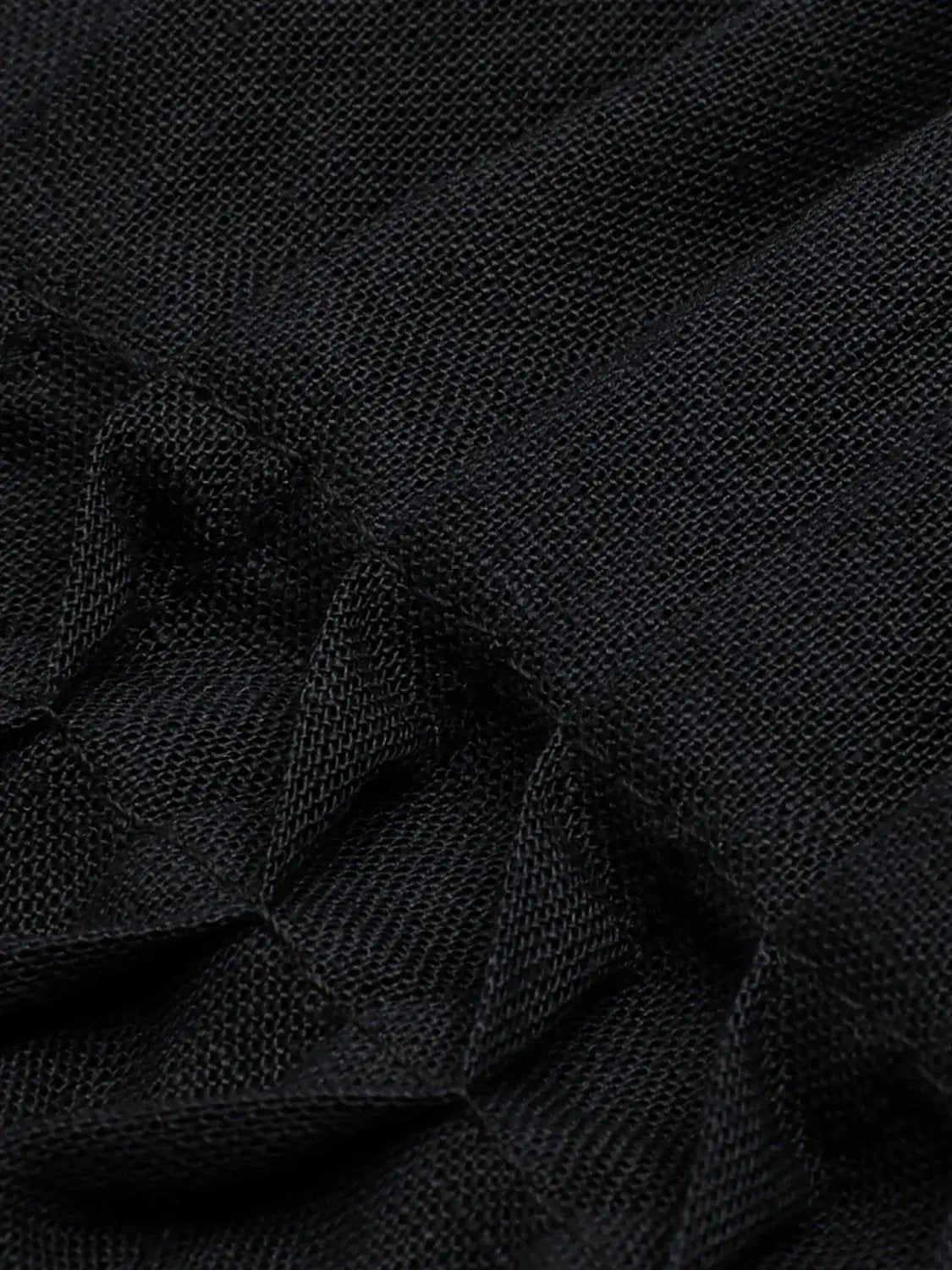 V-neck puff sleeve smocked waist cotton-linen blend blouse; black textured fabric close-up