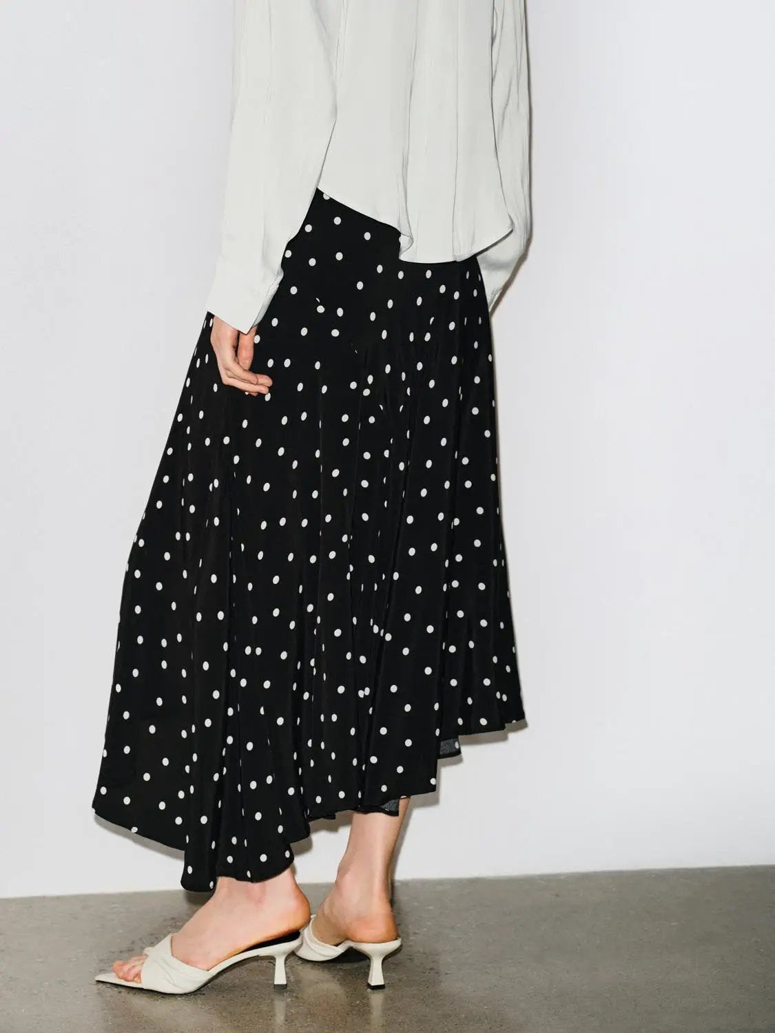Polka dot asymmetric-hem maxi wrap skirt in black with white dots, Urban Revivo Fashion.