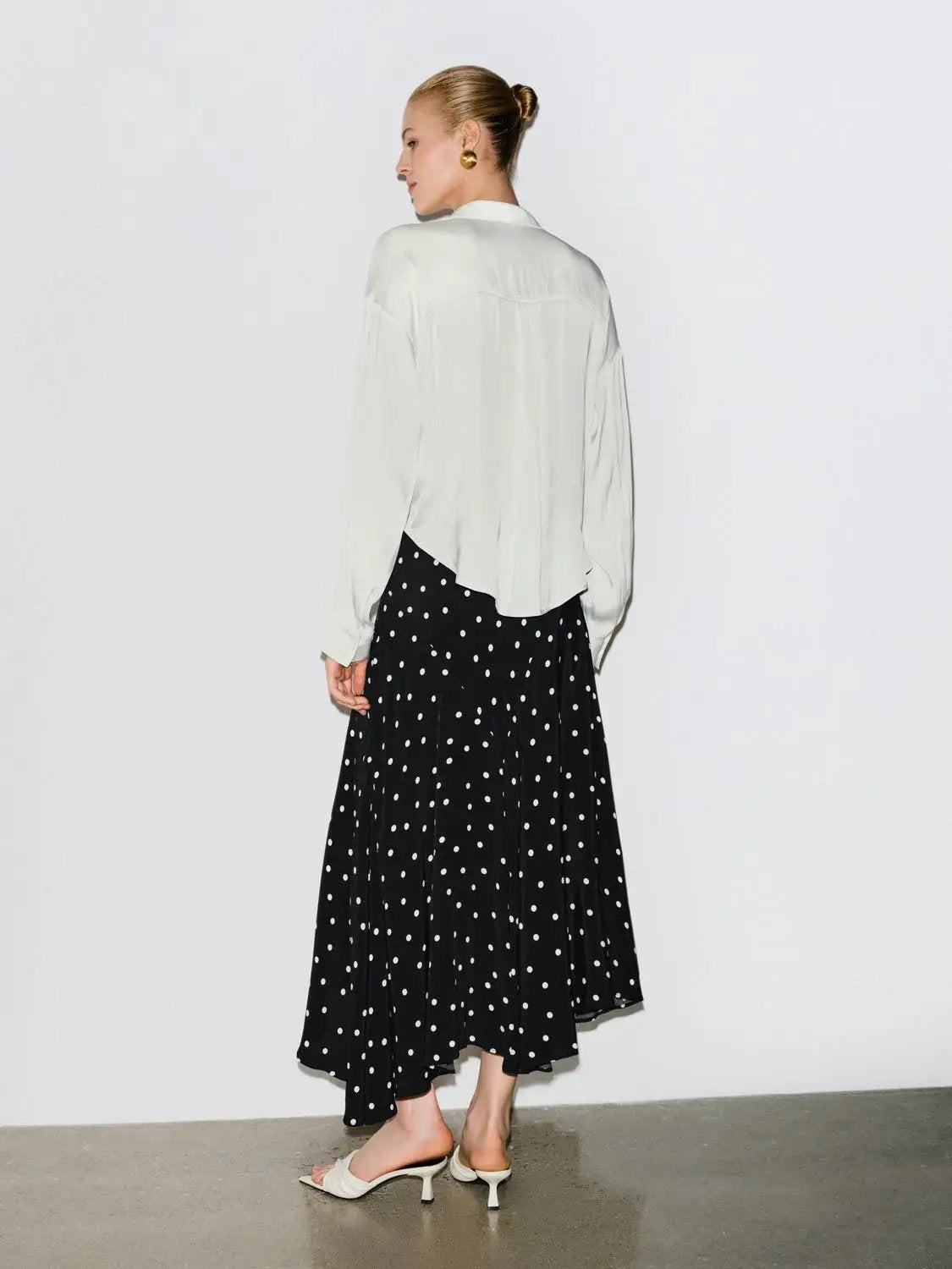 Polka Dot Asymmetric Hem Maxi Wrap Skirt in black with white polka dots.