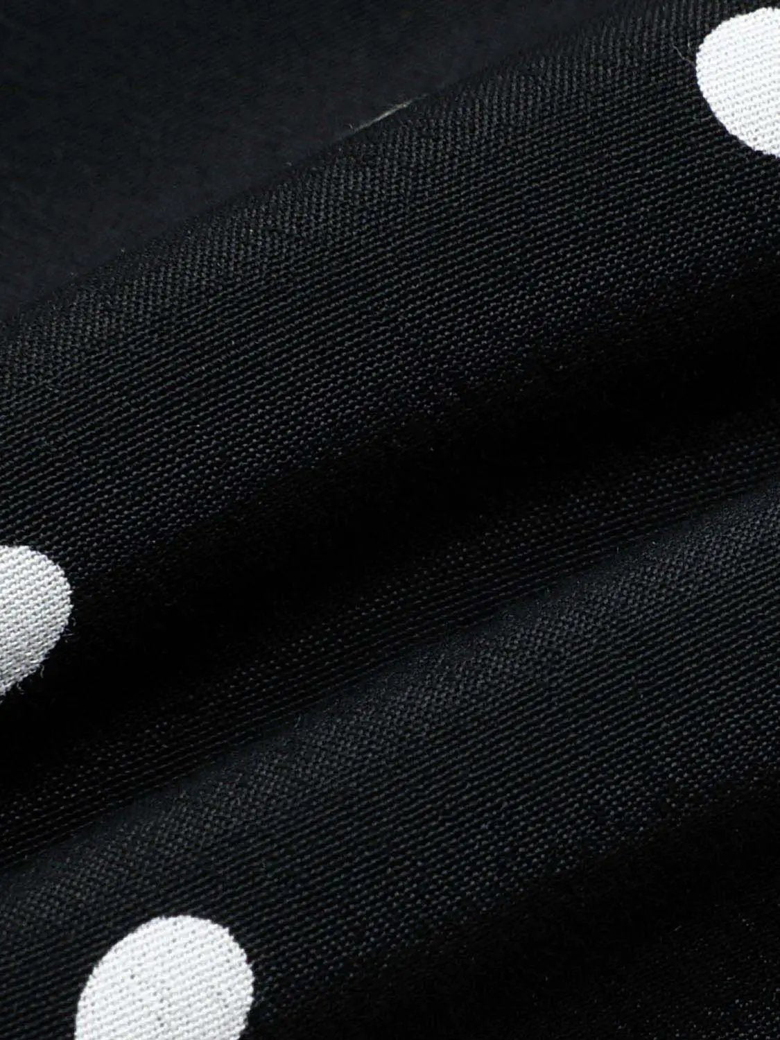 Polka Dot Asymmetric Hem Maxi Wrap Skirt in black with white polka dots.