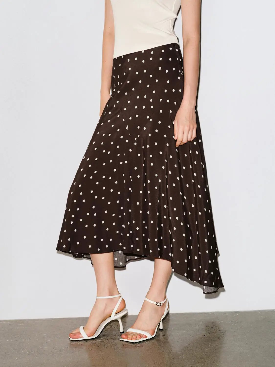 Polka Dot Asymmetric Hem Maxi Wrap Skirt in brown with white polka dots; flowy silhouette.