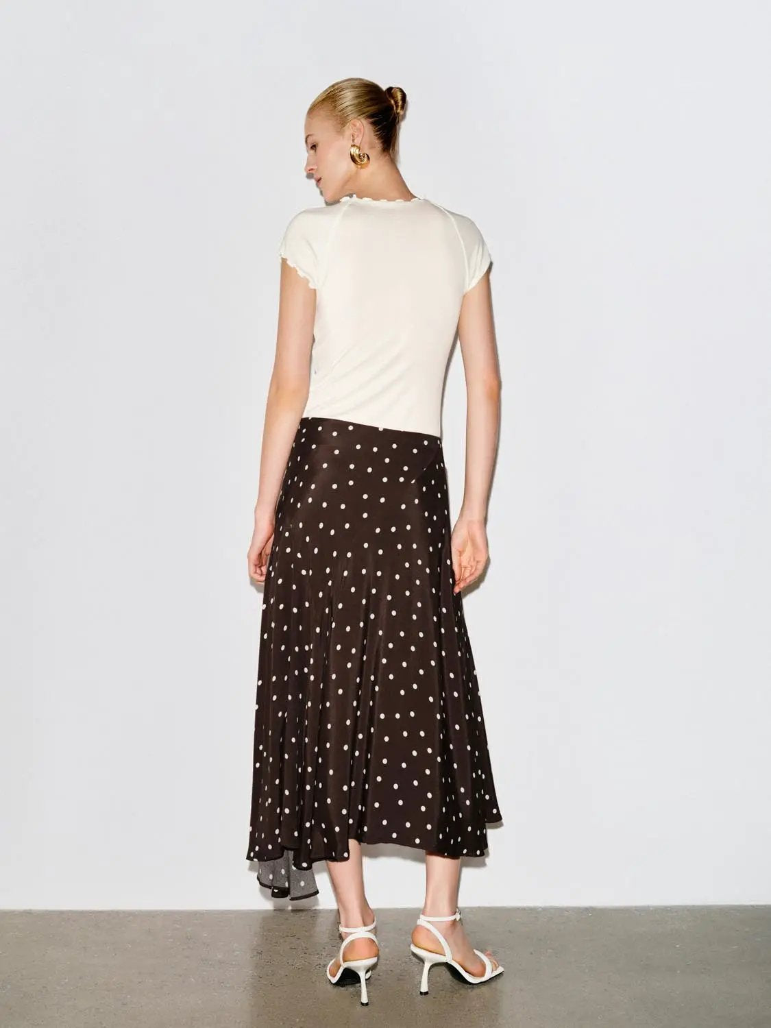 Polka Dot Asymmetric Hem Maxi Wrap Skirt in brown with white polka dots.