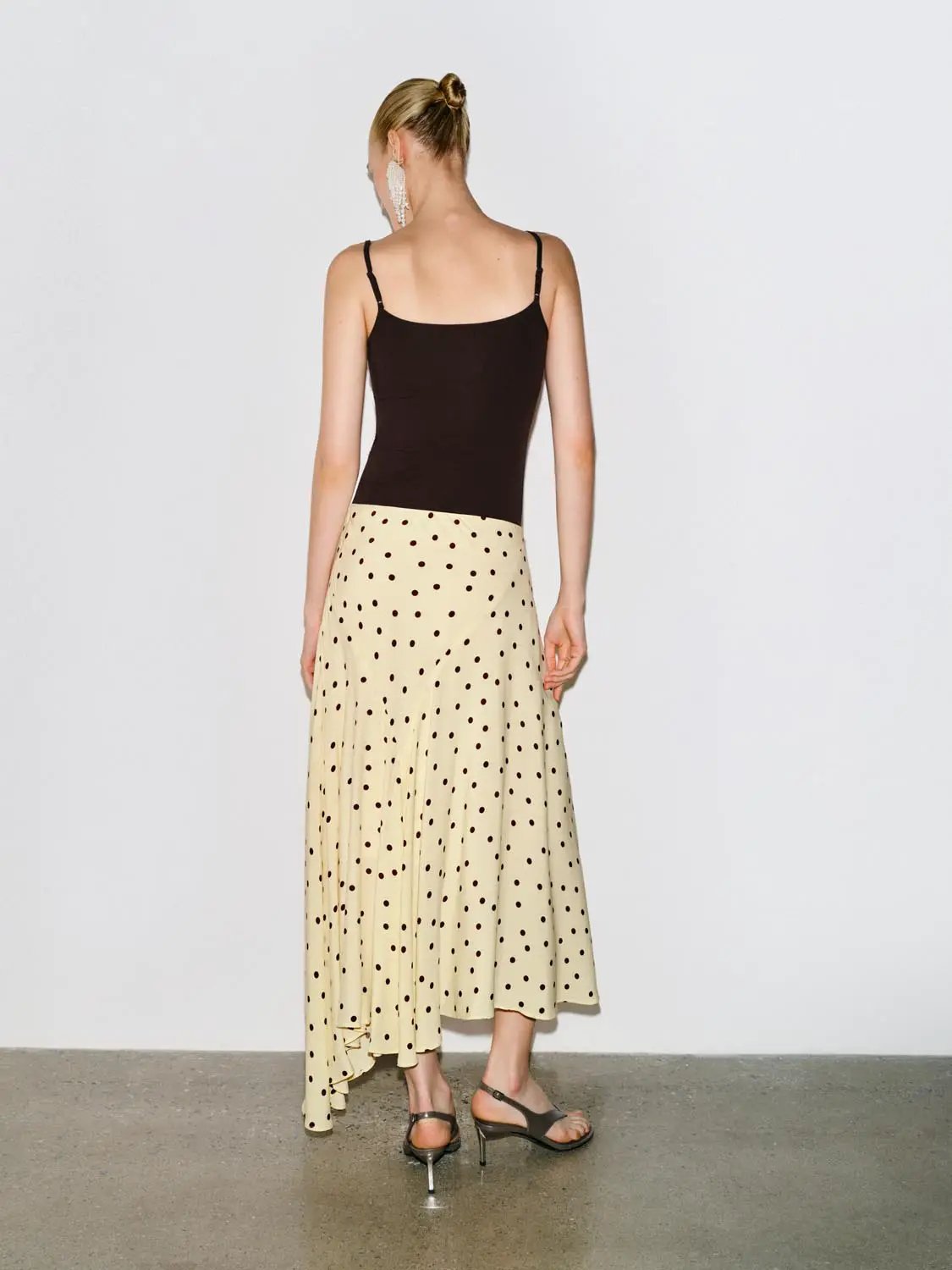 Polka Dot Asymmetric Hem Maxi Wrap Skirt; cream base with black polka dots, back view on model.
