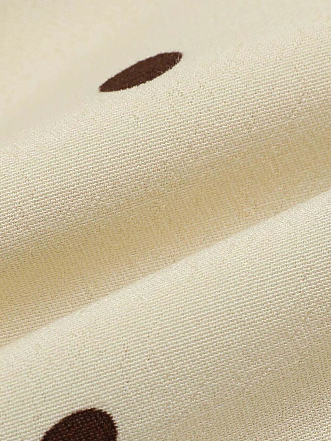 Polka Dot Asymmetric Hem Maxi Wrap Skirt in beige fabric with brown polka dots