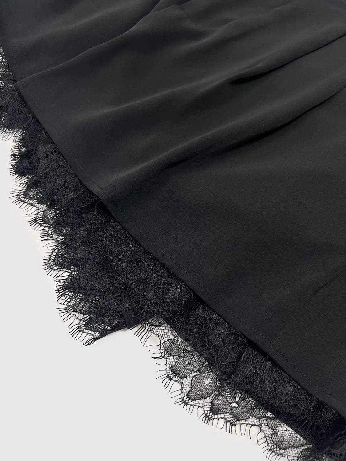 Lace Trim Shorts in black fabric with a delicate lace hem.