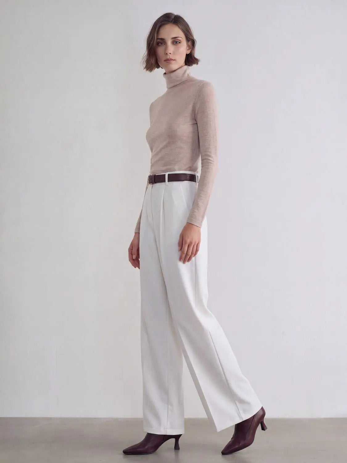 Wide-leg pants white with brown belt, high-waisted tailored look