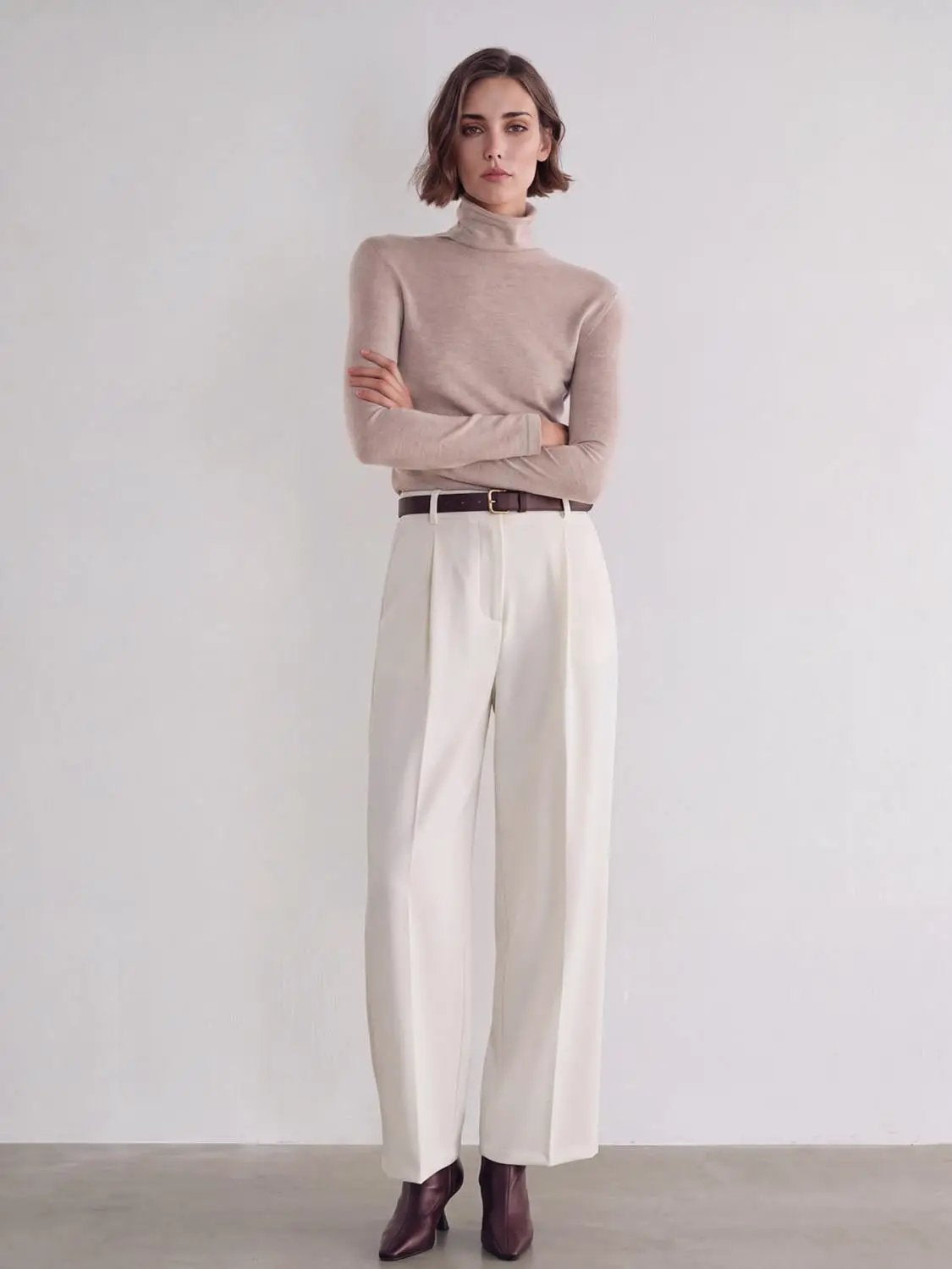Cream wide-leg pants with a brown belt, high-waisted tailored fit