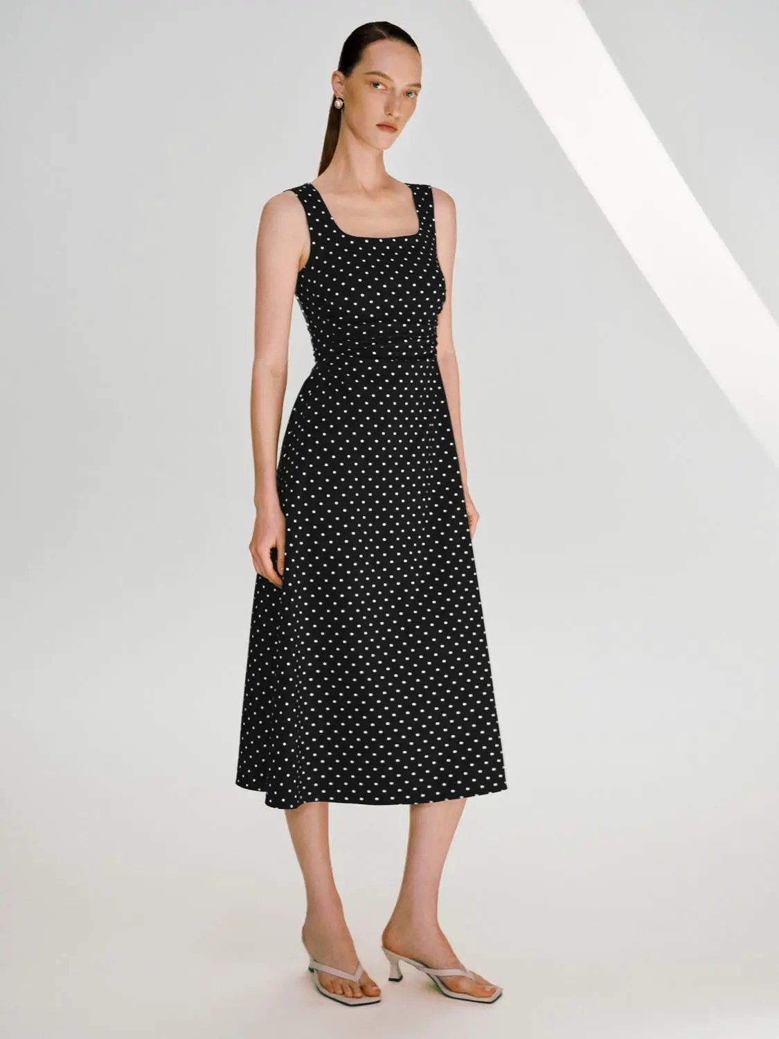 Polka dot knit sleeveless A-line dress with a flattering fit in black and white