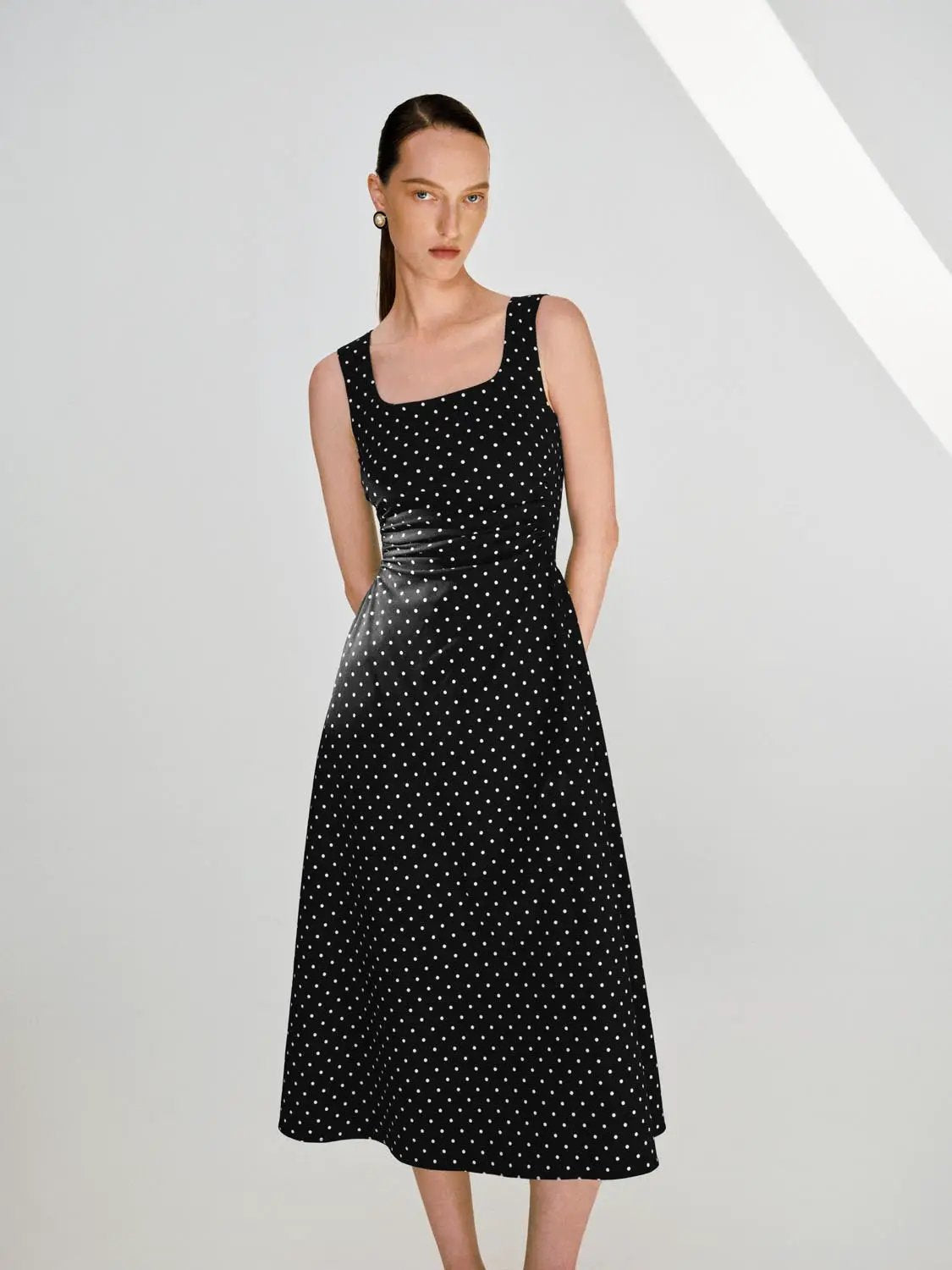 Polka dot knit sleeveless A-line midi dress in black with white dots