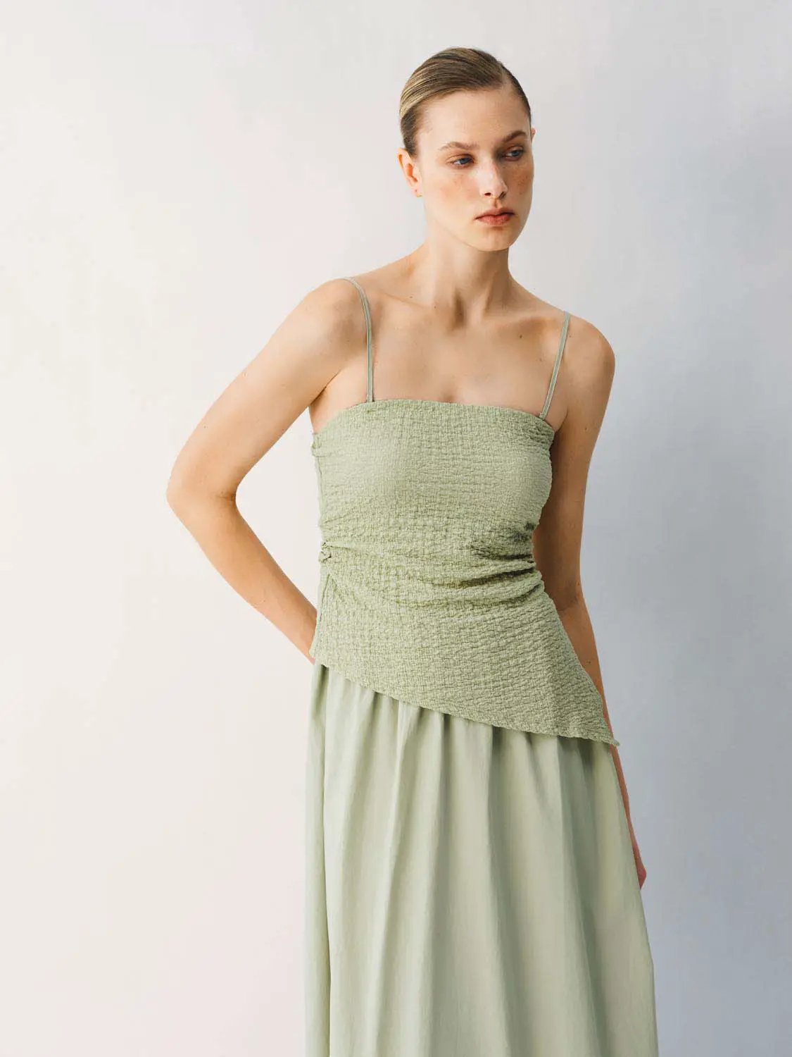 Thin stretch fabric strappy A-line midi dress in sage green with a smocked bodice and flowing skirt