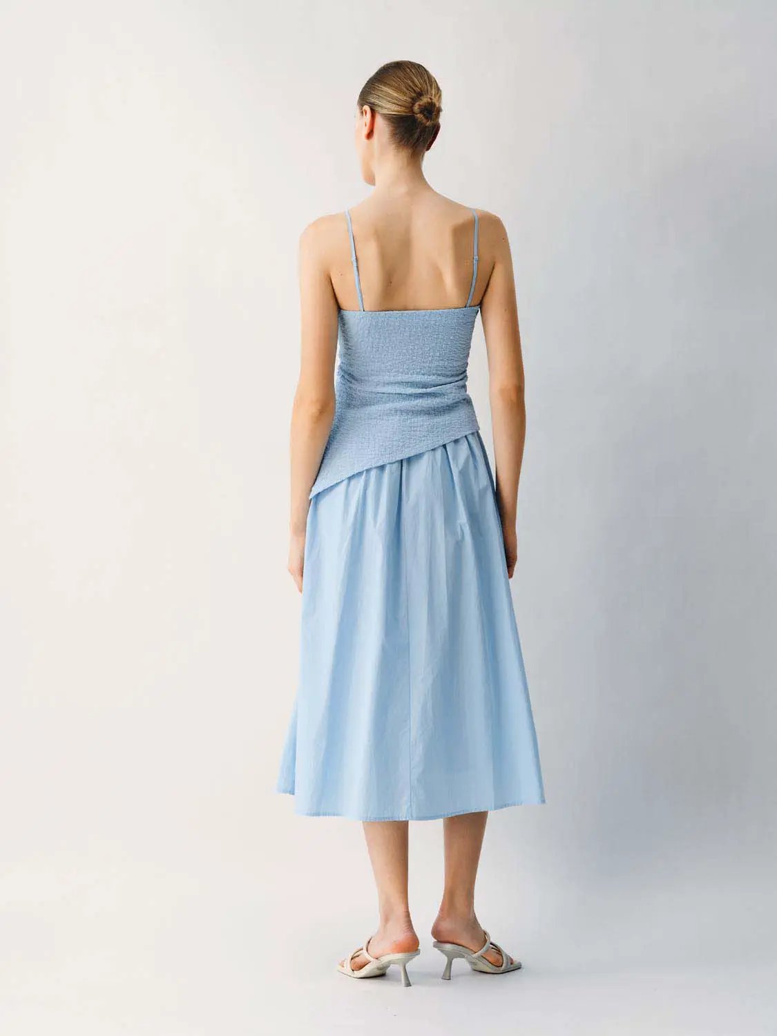 Thin stretch fabric strappy blue A-line midi dress with spaghetti straps, back view