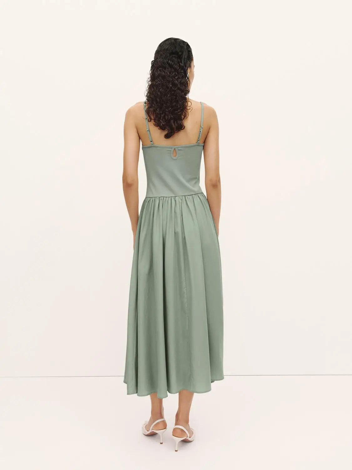 A-line dress in sage green with spaghetti straps and back keyhole detail.