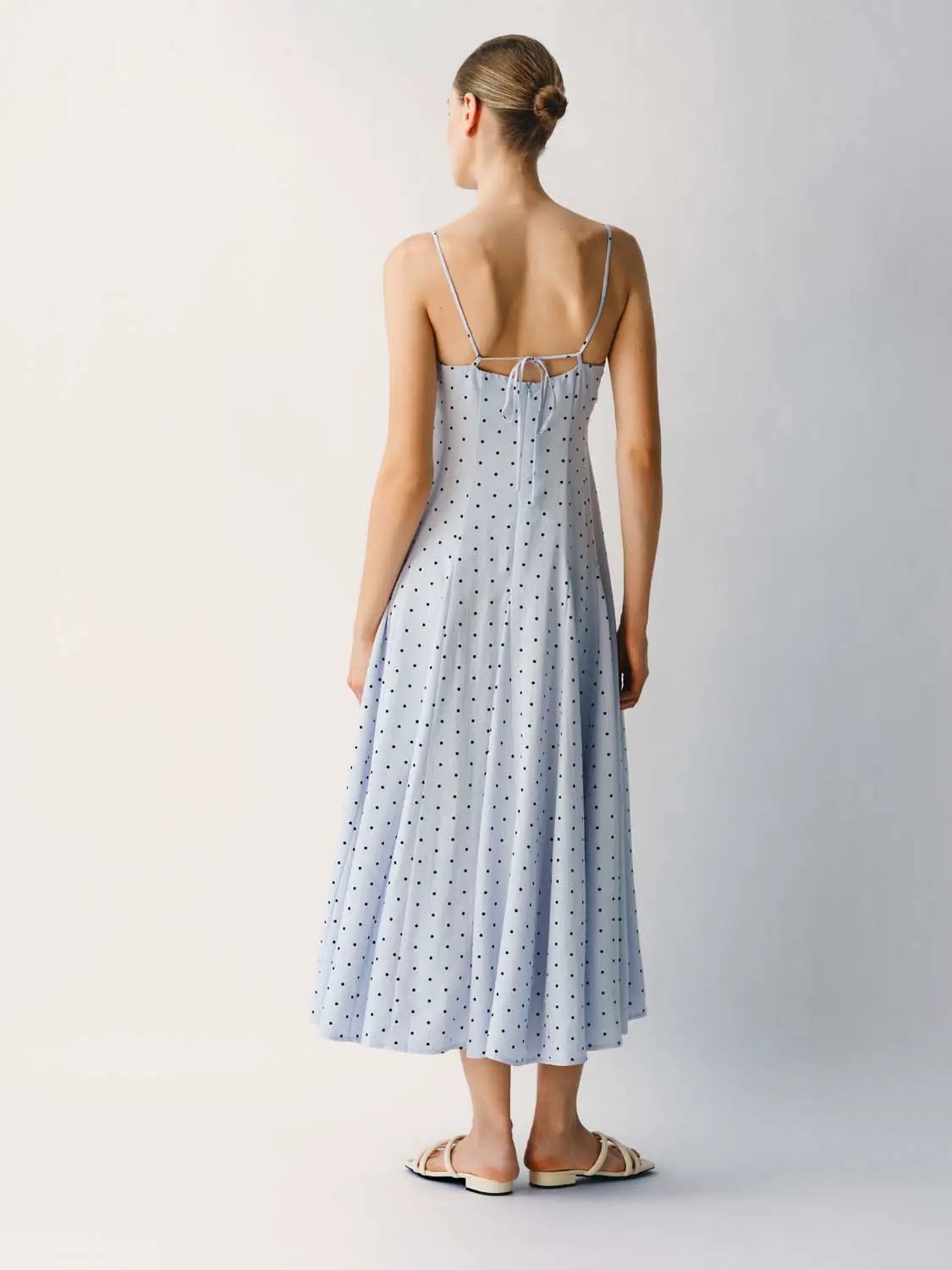 Polka Dot A-Line Dress; light-blue with black spots, back-tie, spaghetti straps, midi length by Urban Revivo Fashion