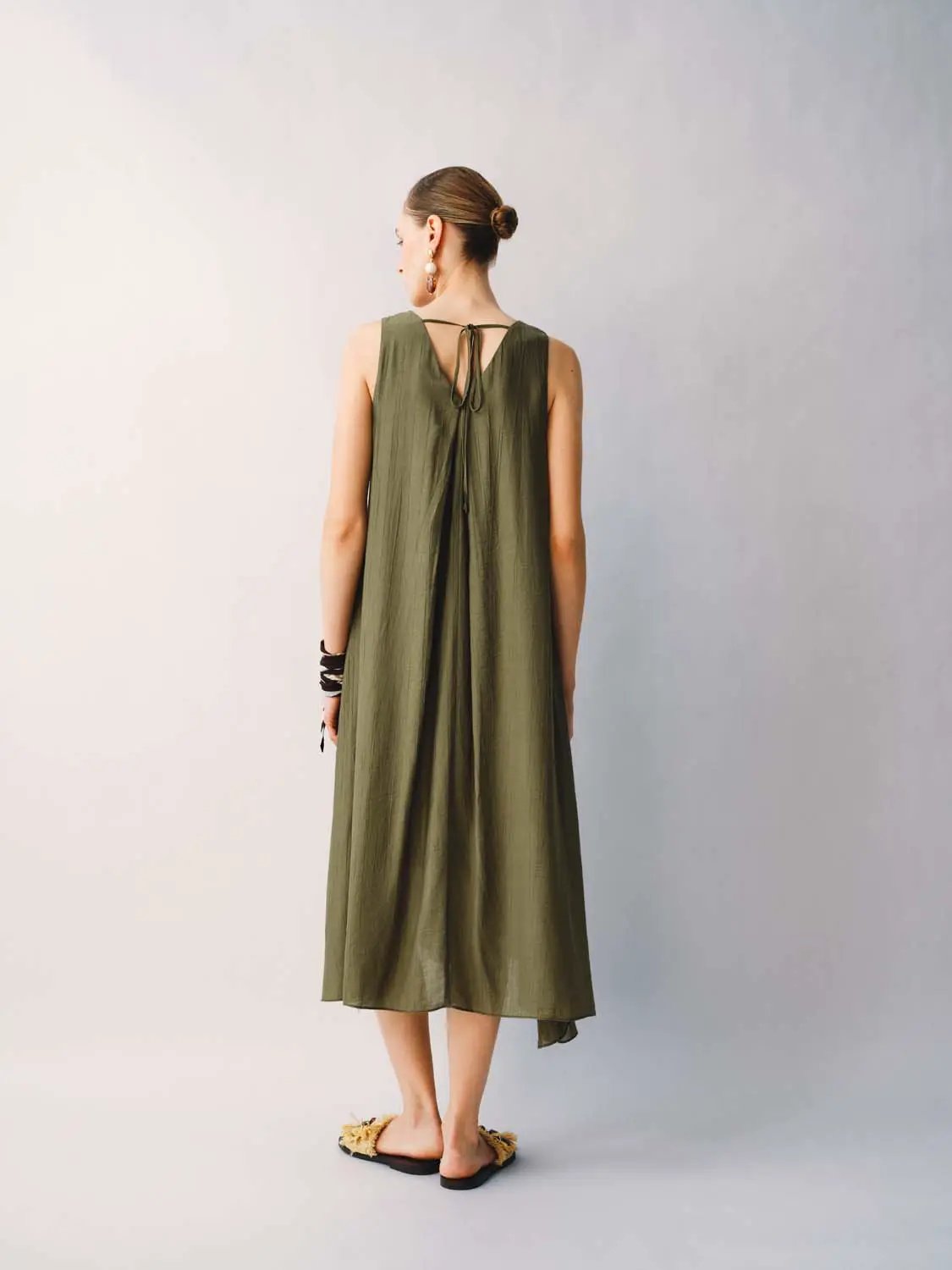 Olive-green sleeveless A-line midi dress with lightweight fabric and back tie detail