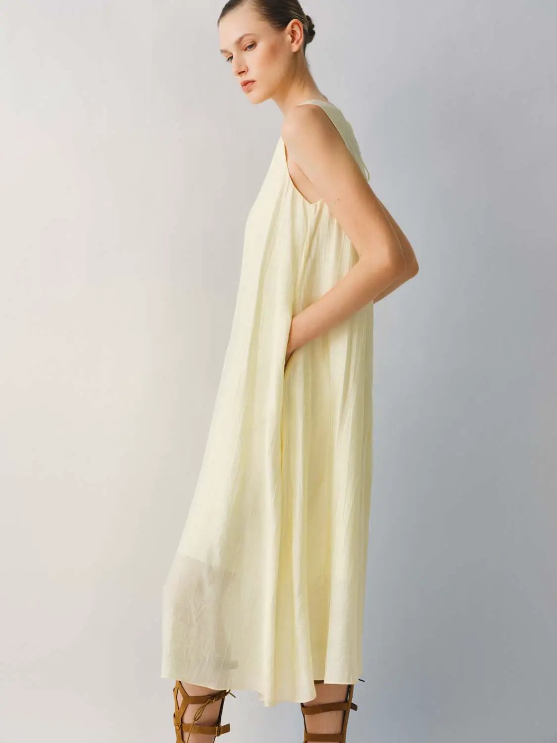 Slight Stretch A-Line Dress in pale yellow, lightweight thin fabric, sleeveless, midi-length