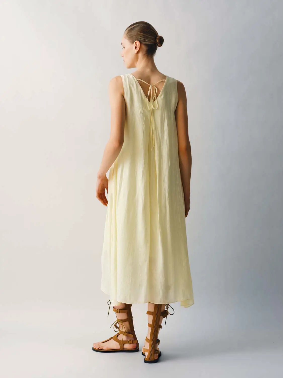 Slight Stretch A-Line Dress in pale yellow with back tie detail