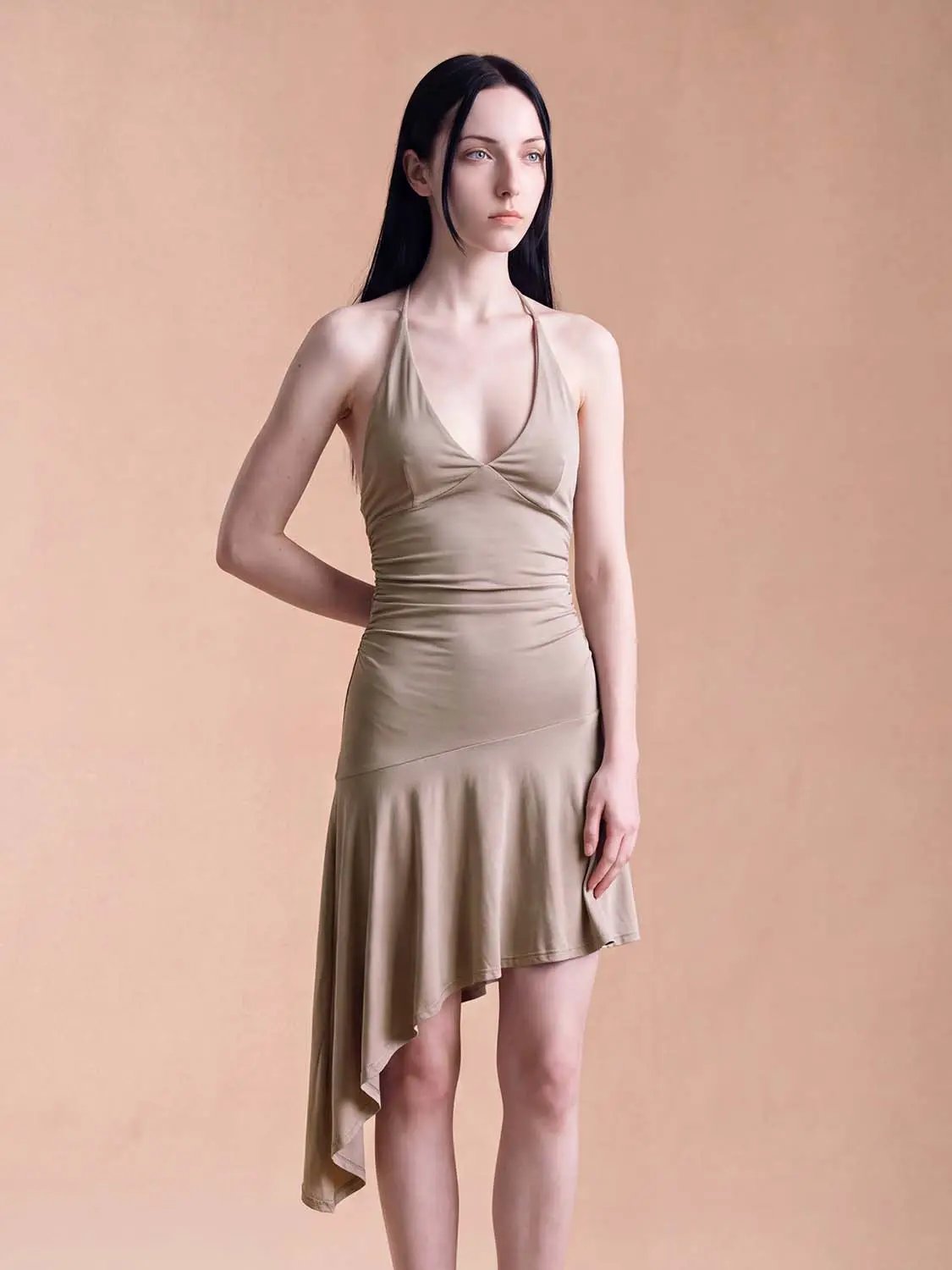 A-Line Dress in beige satin with halter neckline, ruched waist, and asymmetric high-low hem
