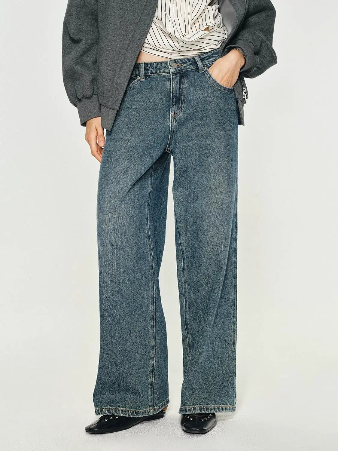 Mid-rise medium-wash cotton wide-leg jeans on a model